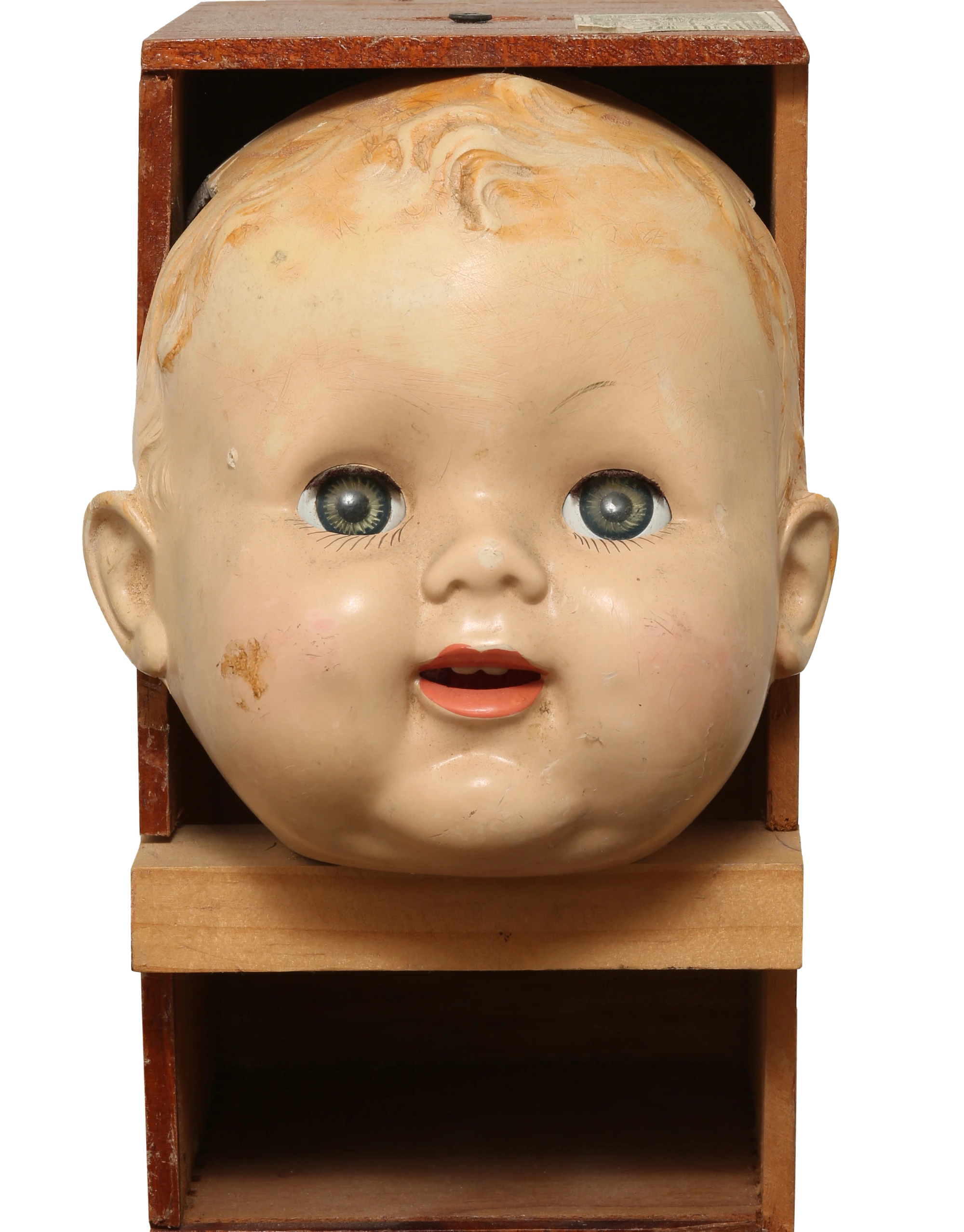 Plaster doll's head set inside a small wooden cabinet — from the estate's sculpture archive